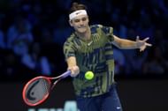 Taylor Fritz returns a shot to Rafael Nadal during their round-robin match at the Nitto ATP Finals